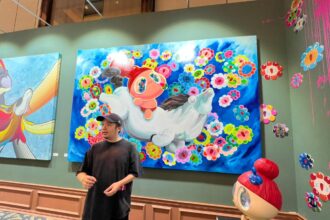 Seniman yang menggabungkan seni pop art dan old master, Peter Rhian Gunawan di depan salah satu karya lukisannya. Foto: Ist