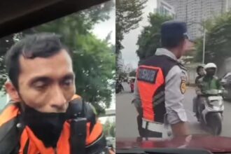 Petugas Dishub berada diatas kap mobil setelah cekcok dengan taksi online. Foto: IG, @terang_media (tangkap layar)