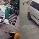 Pria berkaus kuning menenteng pistol kemudian menembak bagian bawah mobil yang parkir di sebuah rumah menembak mati kucing. Foto: X, @banyulangit_ (tangkap layar)