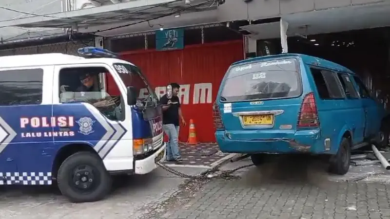 Polisi evakuasi angkot yang menabrak warga dan toko di Jalan Raya Margonda, Depok. (Istimewa)