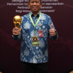 Kepala BPJS Kesehatan Cabang Jakarta Utara, Ropik Patriana menuju kegiatan UHC Awards