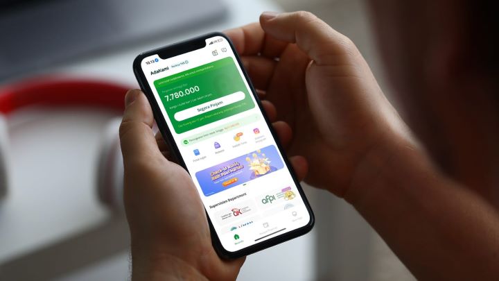 Salah seorang pengguna smartphone menggunakan aplikasi AdaKami. Foto: Ist