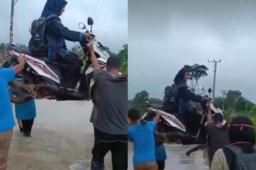 Seorang guru SD di Banyuasin digotong bersama motornya oleh warga untuk melewati banjir menuju sekolah. Foto: Tangkapan layar X @pai_c1