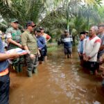 Kepala Badan Nasional Penanggulangan Bencana (BNPB) Suharyanto dan jajaran bersama Pemda setempat saat meninjau lokasi terdampak banjir di Desa Kuala Mandor A, Kabupaten Kubu Raya, Kalimantan Barat, pada Jumat (31/1/2025). Foto: BNPB