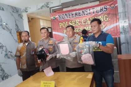 Kapolsek Cakung, Kompol Widodo Saputro (tengah) didampingi Kanit Reskrim Polsek Cakung (kanan) dan Corporate Security PT JIEP, Suhendi (kiri) menunjukkan barang bukti pengungkapan kasus begal dengan menghadirkan tersangka inisial FL, 25, di Mapolsek Cakung, Jakarta Timur, Rabu (1/10/2025). Foto: Joesvicar Iqbal/ipol.id