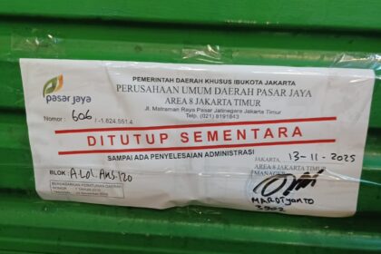 Perumda Pasar Jaya melalui pengelola Pasar Pramuka menempelkan stiker penutupan sementara kios pedagang yang tidak membayar sewa, Kamis (13/11/2025). Foto: Joesvicar Iqbal/ipol.id