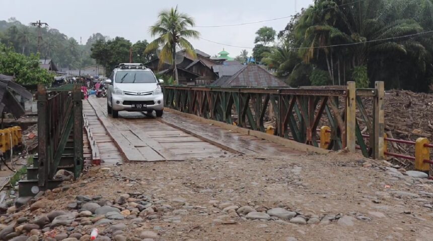 Kendaraan roda empat melintas di jembatan baily dari arah Provinsi Tapanuli Tengah menuju Tapanuli Selatan melalui Desa Garoga, Batang Toru, Minggu (14/12/2025). Foto: Ist