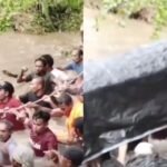 Warga Desa Salube, Kecamatan Loloda Kepulauan, Halmahera Utara, Maluku Utara, bergotong royong menyeberangkan keranda jenazah melewati sungai berarus deras akibat jembatan menuju area pemakaman ambruk diterjang banjir, Senin (12/1/2026). Foto: TikTok @pardidu.tabalai