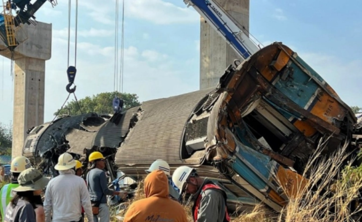 Para pekerja mencari korban di reruntuhan kereta penumpang setelah derek konstruksi roboh menimpa kereta tersebut di distrik Sikhio, Nakhon Ratchasima, Thailand. Foto: EPA