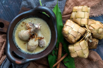 Ilustrasi opor ayam dan ketupat lebaran. Foto: Istcok @Valens Hascaryo