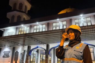 Personel PLN ULP Jayapura Kota, Zahro Ardhillah terus memantau keandalan sistem kelistrikan melalui radio komunikasi pada malam hari menjelang Idulfitri 1447 Hijriah (20/3). Ia rela melewatkan momen kumpul keluarga di kampung halaman agar suplai listrik tetap aman dan masyarakat Jayapura dapat merayakan Idulfitri dengan tenang. Foto: PLN