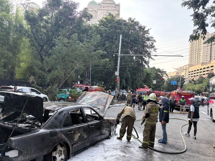 Penampakan mobil Mercedes Benz nopol B 1436 ZDY hangus terbakar di kawasan Permata Hijau, No. 8, Blok B, RT 008/RW 02, Grogol Utara, Kebayoran Lama, Jakarta Selatan, sekitar lampu merah Apartemen Permata Hijau, Rabu (18/3/2026) sore. Sejumlah petugas Damkar setempat bergegas memadamkan di lokasi. Foto: Joesvicar Iqbal/ipol.id