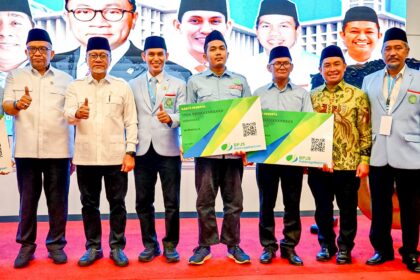 Menko Pangan Zulkifli Hasan menyerahkan kartu BPJS Ketenagakerjaan kepada guru ngaji. Foto: Ist
