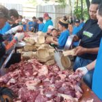 Panitia kurban melakukan pengemasan daging menggunakan besek bambu untuk dibagikan kepada warga sekitar di Pasar Induk Kramat Jati, Jakarta Timur, Kamis (28/5/2026). Foto: Joesvicar Iqbal/ipol.id